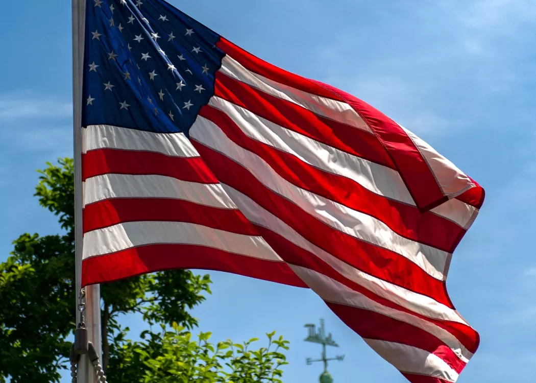 American flag waving in the wind on Belknap Campus