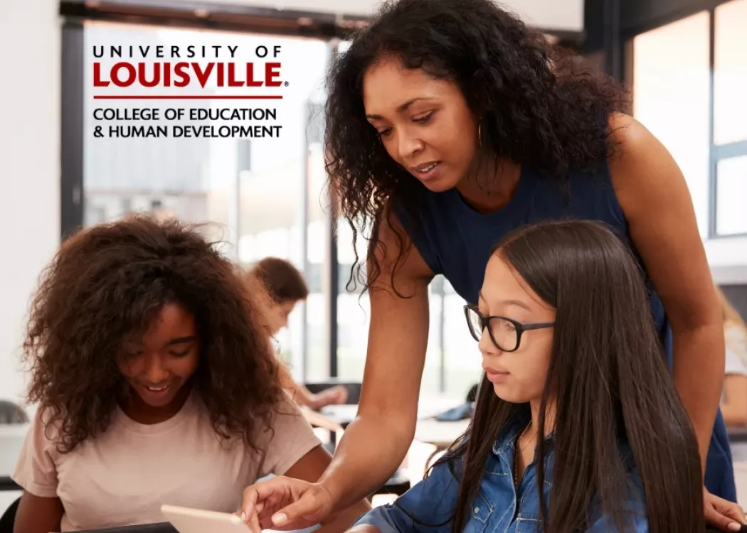 Image of female teacher helping two students who are learning on their electronic learning devices